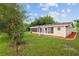 The rear exterior view displays the Florida room and exterior color scheme at 9940 Sw 101St Pl, Ocala, FL 34481