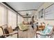 Bright sunroom features cozy seating, a desk area, and lots of natural light at 9940 Sw 101St Pl, Ocala, FL 34481