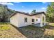 Side view of the home showcasing a covered patio and backyard with ample space at 14540 Se 33Rd Ter, Summerfield, FL 34491