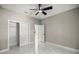 A well-lit bedroom with a fan, closet, and marble floors at 14540 Se 33Rd Ter, Summerfield, FL 34491