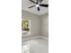 Bedroom featuring a ceiling fan, natural light from the exterior window, and sleek marble floors at 14540 Se 33Rd Ter, Summerfield, FL 34491