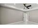 Bedroom with neutral walls, marble floors, door to an en suite bathroom, and a modern ceiling fan at 14540 Se 33Rd Ter, Summerfield, FL 34491