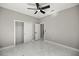 A spacious bedroom with a fan, closet, and marble floors at 14540 Se 33Rd Ter, Summerfield, FL 34491