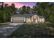 Charming single-story home featuring a manicured lawn, neutral paint, and a two-car garage at 14540 Se 33Rd Ter, Summerfield, FL 34491