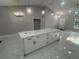 Spacious kitchen island with white quartz countertops and modern black hardware on white cabinetry at 14540 Se 33Rd Ter, Summerfield, FL 34491