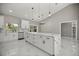 Spacious kitchen featuring an island with a marble countertop, sleek appliances, and modern lighting at 14540 Se 33Rd Ter, Summerfield, FL 34491
