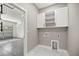 Laundry room with sleek cabinets, utility sink, and marble flooring at 14540 Se 33Rd Ter, Summerfield, FL 34491