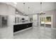 A spacious living room and kitchen space with a marble floor and a large kitchen island at 14540 Se 33Rd Ter, Summerfield, FL 34491