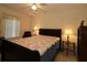 Comfortable bedroom with a ceiling fan and a bed with a decorative quilt at 15324 Sw 28Th Avenue Rd, Ocala, FL 34473