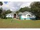 Charming single-story home with a well-manicured lawn, double front doors, and eye-catching turquoise accents at 15324 Sw 28Th Avenue Rd, Ocala, FL 34473