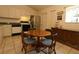Functional kitchen with wooden table and chairs, stainless steel refrigerator, and tile flooring providing a cozy atmosphere at 15324 Sw 28Th Avenue Rd, Ocala, FL 34473