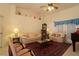 Bright living room featuring comfortable seating, a ceiling fan, and piano offering a relaxed and inviting ambiance at 15324 Sw 28Th Avenue Rd, Ocala, FL 34473