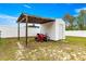 Fenced backyard featuring a shed, covered area, and a riding lawnmower at 16220 Sw 19Th Avenue Rd, Ocala, FL 34473