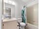 Bright bathroom featuring a vanity with sink, toilet, and shower with a colorful curtain at 16220 Sw 19Th Avenue Rd, Ocala, FL 34473