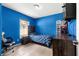 Bedroom featuring blue walls, tiled flooring, a window, bed and a desk with a chair at 16220 Sw 19Th Avenue Rd, Ocala, FL 34473