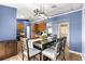 Bright dining area with wood table, stylish light fixture, and blue accent walls at 16220 Sw 19Th Avenue Rd, Ocala, FL 34473