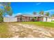 Spacious property featuring a grey single-story home with a fenced yard at 16220 Sw 19Th Avenue Rd, Ocala, FL 34473