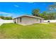 Exterior view of the house showcasing a fenced backyard, grill, and well-maintained lawn at 16220 Sw 19Th Avenue Rd, Ocala, FL 34473