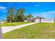 View of property showing a single-story home and large front yard with driveway and fence at 16220 Sw 19Th Avenue Rd, Ocala, FL 34473