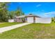 Exterior view of single-story home with large front yard, long driveway, and fenced perimeter at 16220 Sw 19Th Avenue Rd, Ocala, FL 34473