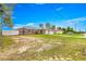 Property featuring a single-story home with a well-kept lawn, driveway, and fenced yard at 16220 Sw 19Th Avenue Rd, Ocala, FL 34473