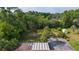 Aerial view of the rooftop, yard and surrounding foliage at 2032 Se 12Th St, Ocala, FL 34471