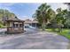 An outdoor space with a gazebo, a swing, palm trees, and lush green grass at 2032 Se 12Th St, Ocala, FL 34471