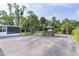 Exterior of home featuring gazebo, mature palm trees, and screened lanai at 2032 Se 12Th St, Ocala, FL 34471