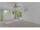Sunlit bedroom featuring plush carpeting and sliding glass doors leading to the outdoors at 2032 Se 12Th St, Ocala, FL 34471