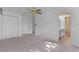 Spacious bedroom featuring plush carpeting, a ceiling fan, and access to an adjoining bathroom at 2032 Se 12Th St, Ocala, FL 34471