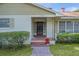 Welcoming front porch with brick accents and decorative wreath on the door, surrounded by lush greenery at 2032 Se 12Th St, Ocala, FL 34471