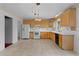 Eat-in kitchen with tile floors, white appliances, and light wood cabinets at 2032 Se 12Th St, Ocala, FL 34471