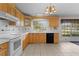 Kitchen with light wood cabinets, white countertops and appliances, and tile backsplash at 2032 Se 12Th St, Ocala, FL 34471