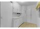 A well-lit laundry room featuring white cabinets and ample storage space at 2032 Se 12Th St, Ocala, FL 34471