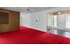 Spacious living room with red carpet, built-in shelving, and a bright entry way at 2032 Se 12Th St, Ocala, FL 34471