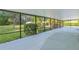 View of a spacious screened porch with a concrete floor overlooking a lush backyard at 2032 Se 12Th St, Ocala, FL 34471