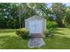 Exterior shot of a weathered utility shed with double doors and a concrete pathway at 2032 Se 12Th St, Ocala, FL 34471