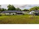 Large backyard with green grass and screened-in patio at 2140 Ne 40Th St, Ocala, FL 34479