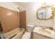 A bathroom featuring a bathtub with shower, toilet, vanity with a unique gold framed mirror at 2140 Ne 40Th St, Ocala, FL 34479