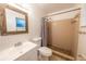 A clean bathroom featuring a framed mirror above the sink and a shower with light colored tile at 2140 Ne 40Th St, Ocala, FL 34479