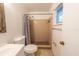 The bathroom features a tiled shower, white toilet, and a mirror above the vanity sink at 2140 Ne 40Th St, Ocala, FL 34479