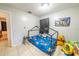 Bedroom featuring tiled flooring, a metal framed bed, and a Paw Patrol wall decoration at 2140 Ne 40Th St, Ocala, FL 34479