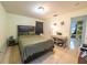 The bedroom boasts a comfortable bed, a study desk, and tile flooring for a practical living space at 2140 Ne 40Th St, Ocala, FL 34479
