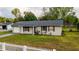 Home exterior with green lawn and white picket fence at 2140 Ne 40Th St, Ocala, FL 34479