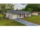 Well-maintained single-Gathering home with attached garage and green lawn at 2140 Ne 40Th St, Ocala, FL 34479