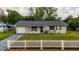 Charming single-story home featuring a well-kept lawn and a classic white picket fence at 2140 Ne 40Th St, Ocala, FL 34479