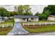 Inviting single-Gathering home with a driveway, grassy lawn, and a charming white picket fence at 2140 Ne 40Th St, Ocala, FL 34479