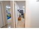 Hallway with open doorway to room, neutral colored floors, and white colored walls at 2140 Ne 40Th St, Ocala, FL 34479
