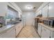 Traditional kitchen with tiled backsplash, white cabinets, and stainless steel appliances at 2140 Ne 40Th St, Ocala, FL 34479