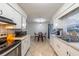 Well-lit kitchen featuring white cabinets, tiled backsplash, and modern appliances at 2140 Ne 40Th St, Ocala, FL 34479